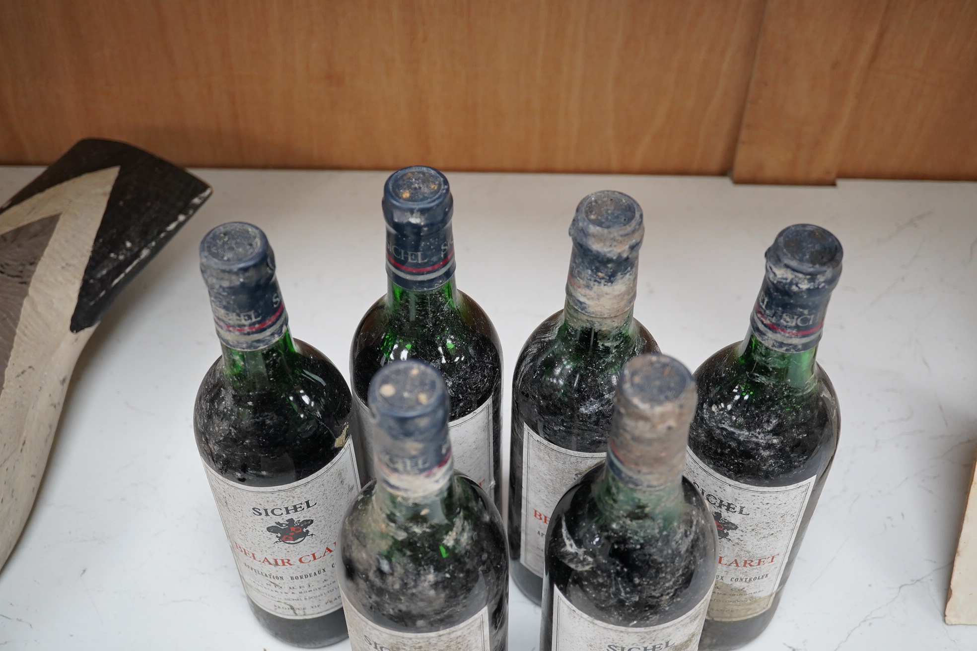 Six bottles of Sichel Belair Claret. Condition - dirty